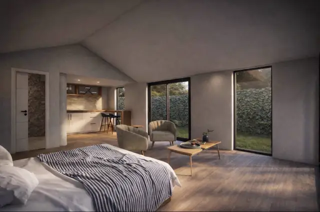 Open plan living with kitchen and garden doors